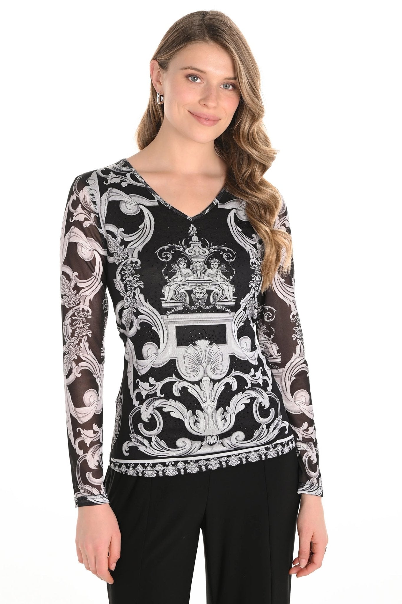 Woman wearing a black and white patterned blouse on a white background