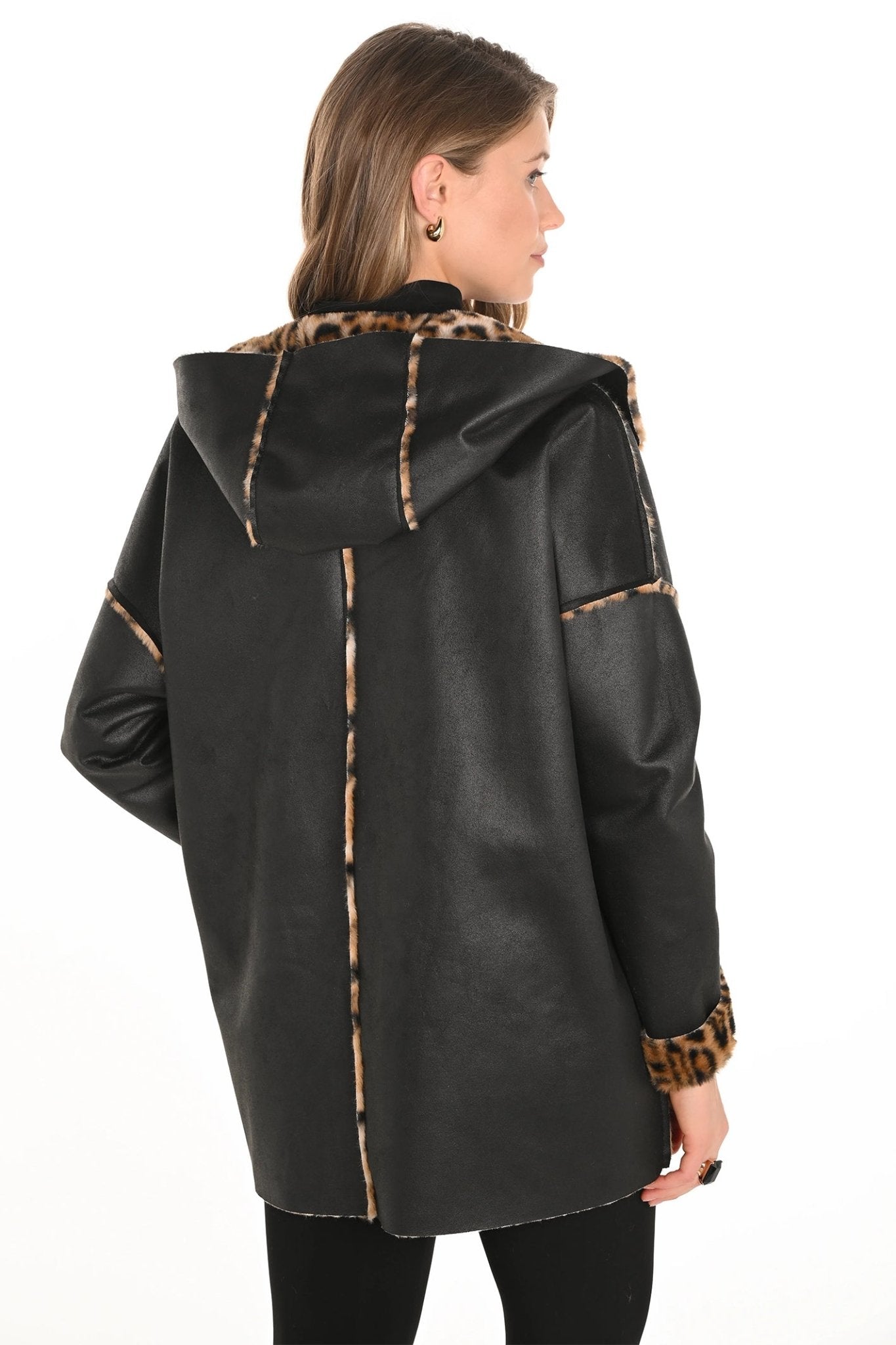 Black leather coat with leopard print trim worn by a model on a white background