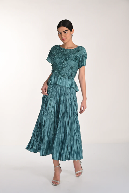 Model wearing Frank Lyman 268521 Green Top and Skirt with textured floral details and pleated skirt by Frank Lyman, shop Frank Lyman at Dotique.