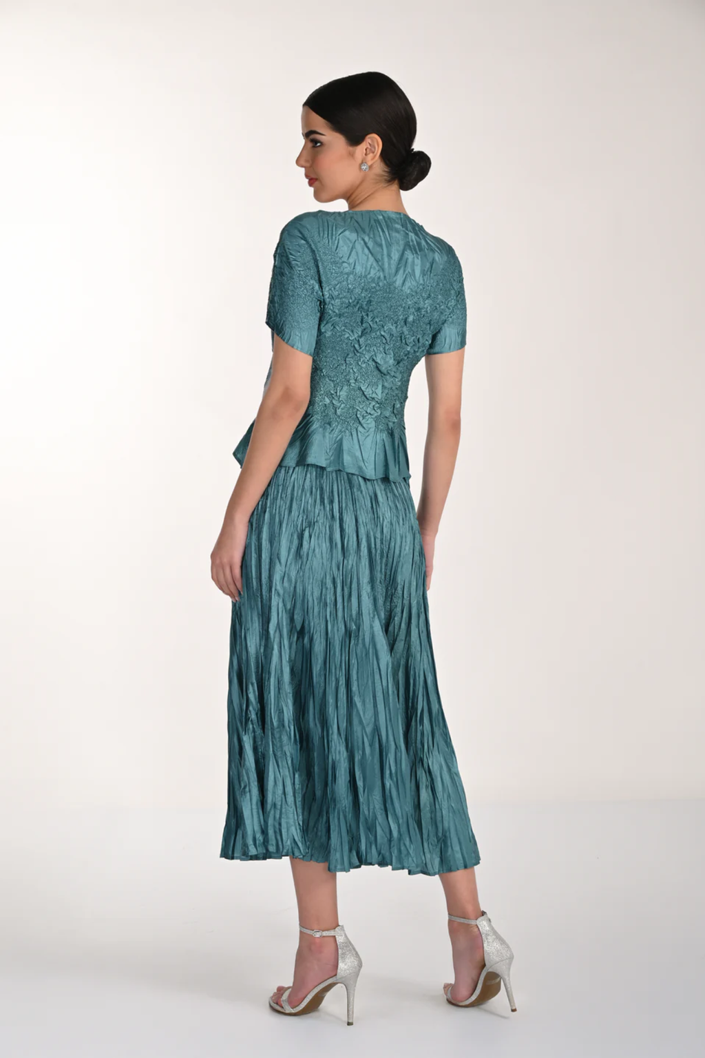 Model showcasing the Frank Lyman 268521 Green Top and Skirt featuring textured fabric and floral detailing by Frank Lyman, shop Frank Lyman at Dotique.