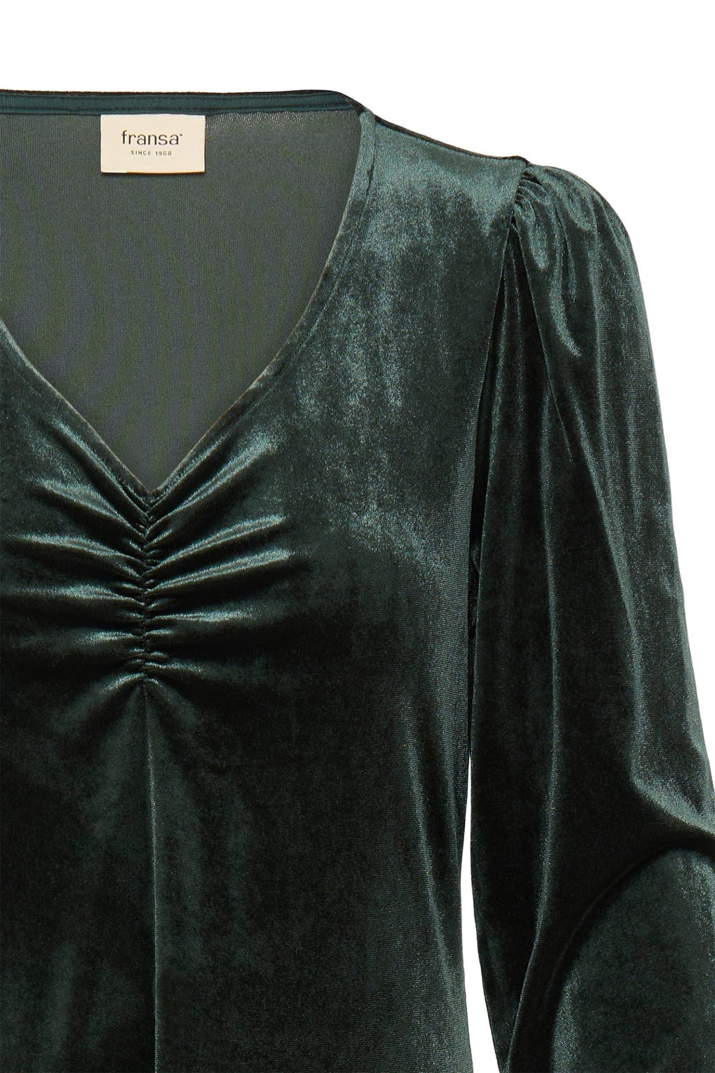 Green velvet dress with a label on a white background