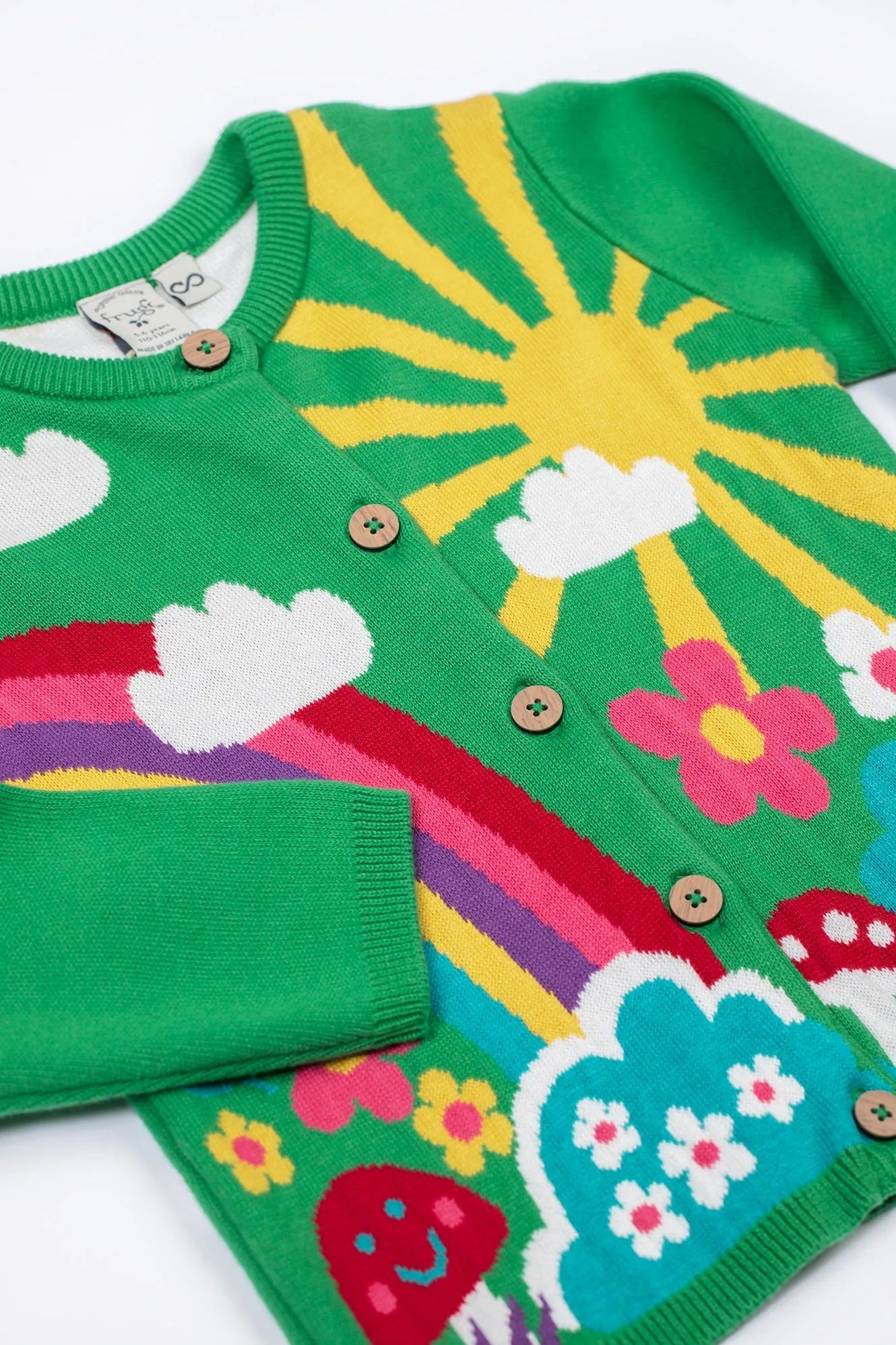Colorful children's cardigan with sun, rainbow, and cloud design on a white background