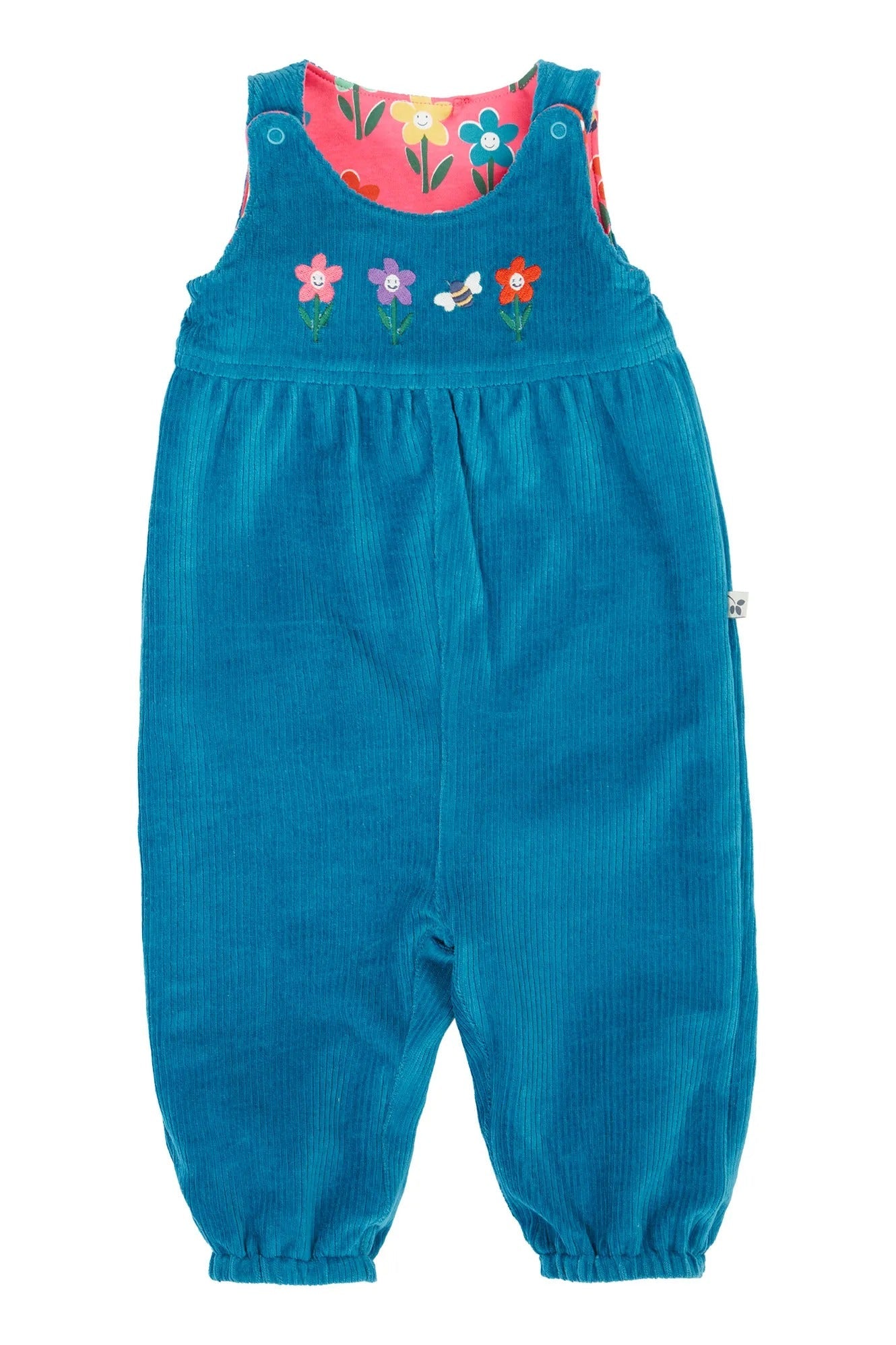 Blue corduroy dungarees with floral patterned top on a white background