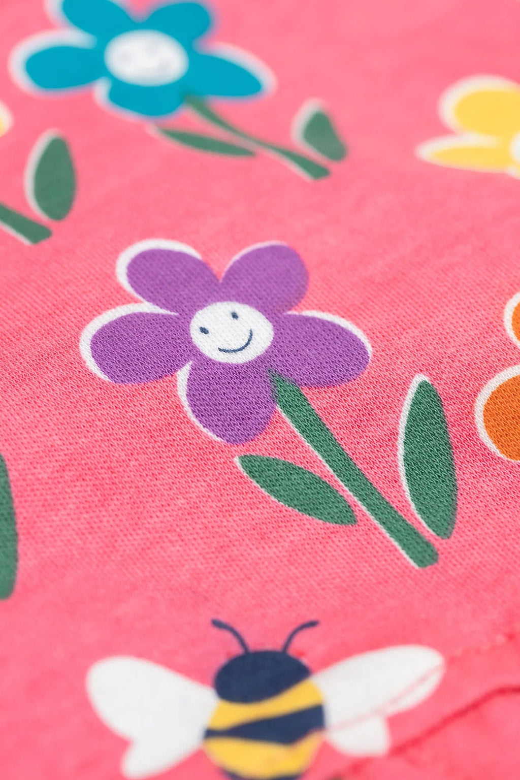 Floral and bee pattern on a pink background