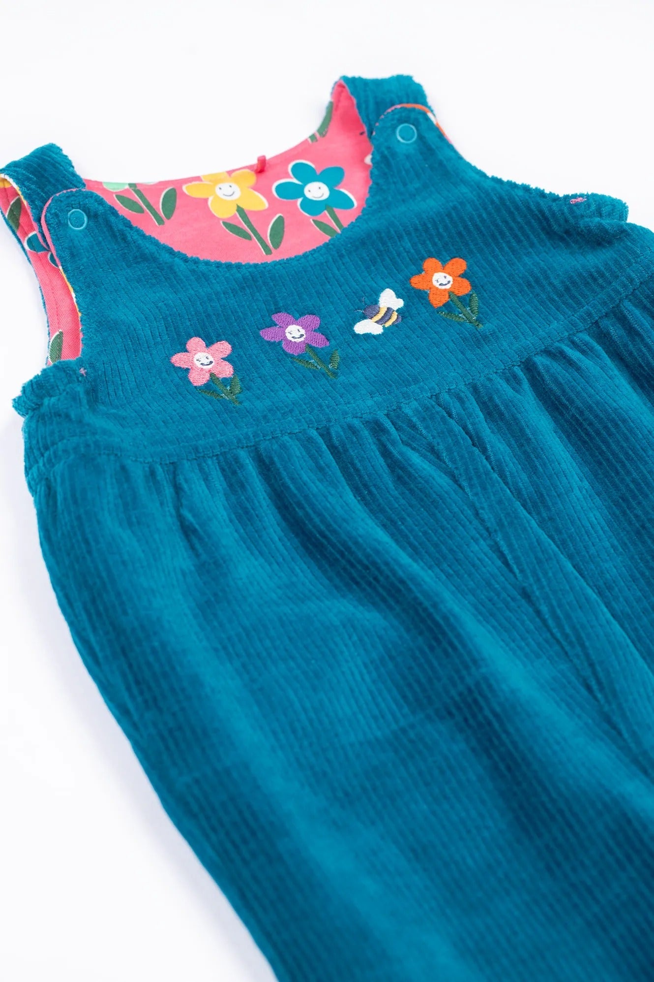 Blue dress with colorful floral embroidery on a white background