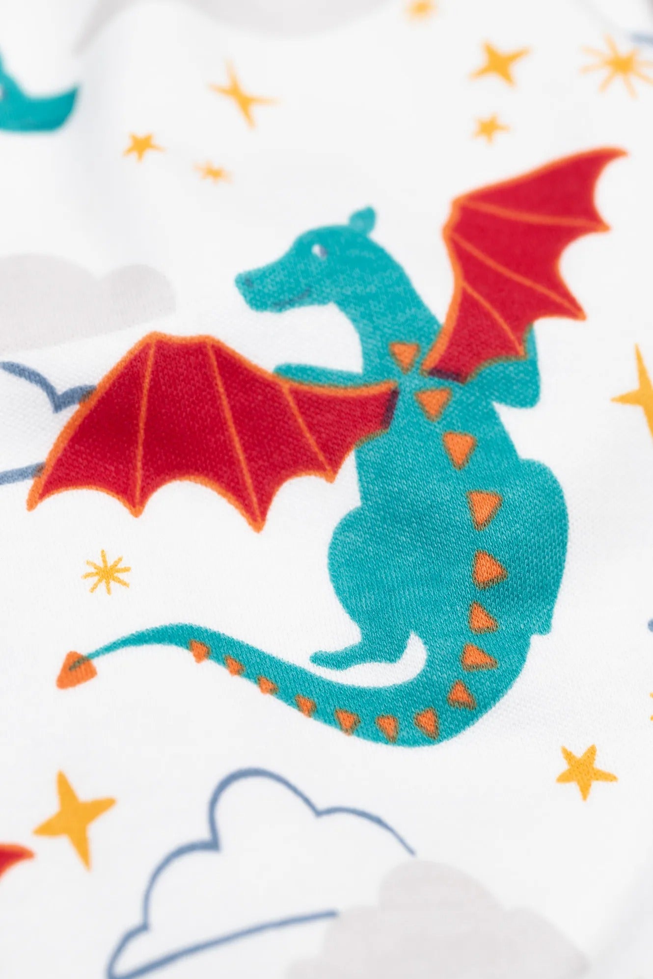 Teal dragon with red wings on a white background with stars and clouds