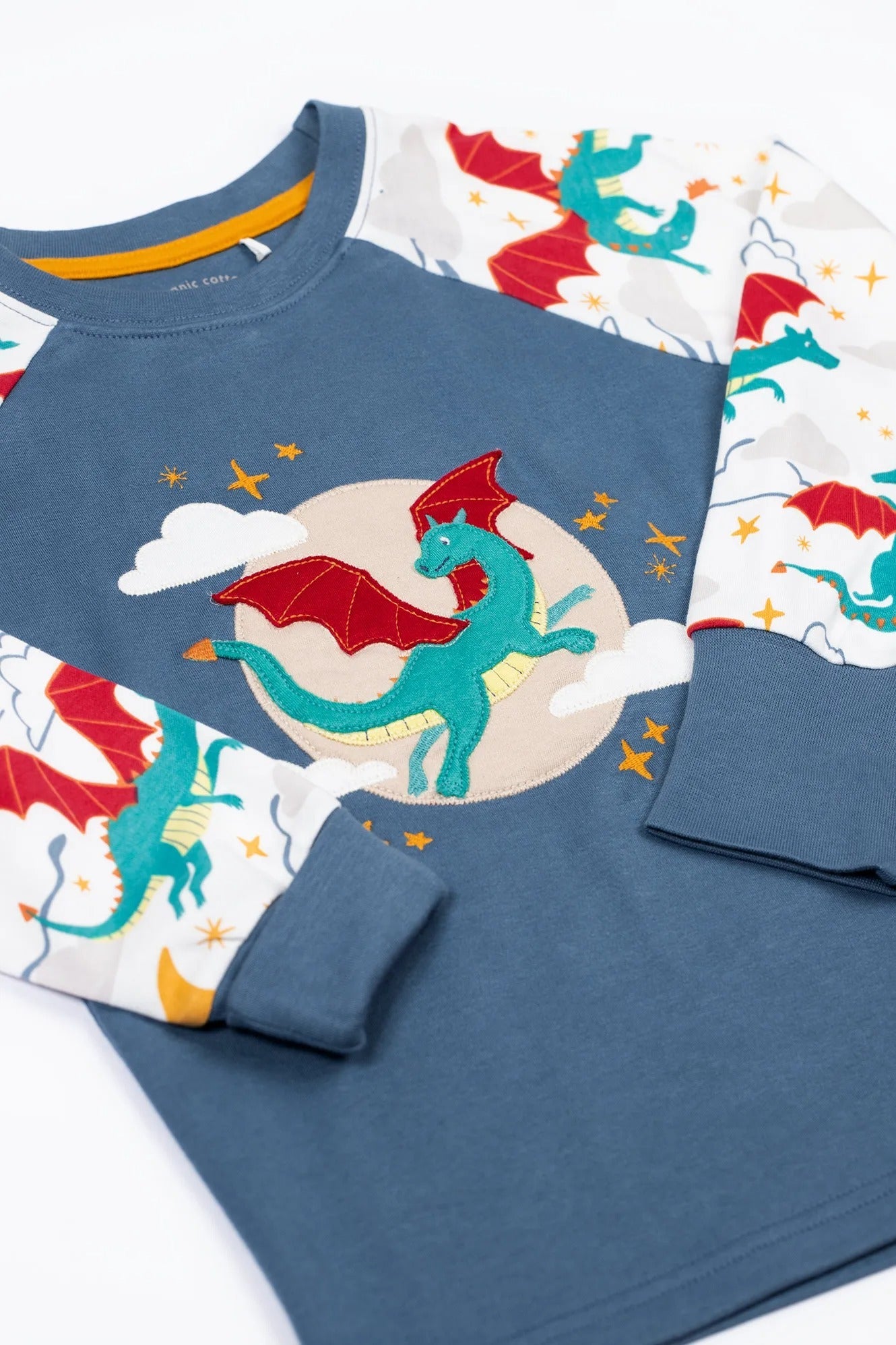 Children's pajama set with dragon design on a white background