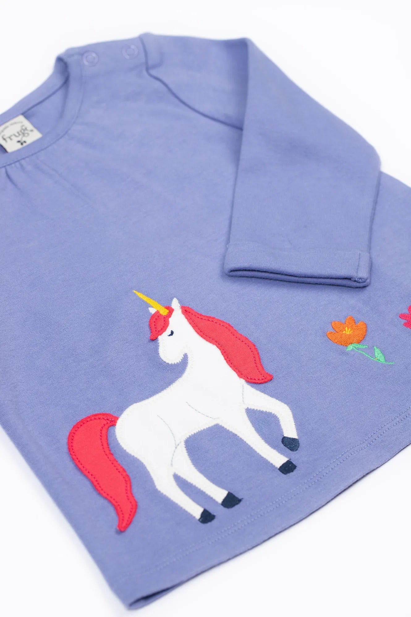 Purple shirt with a unicorn design on a white background