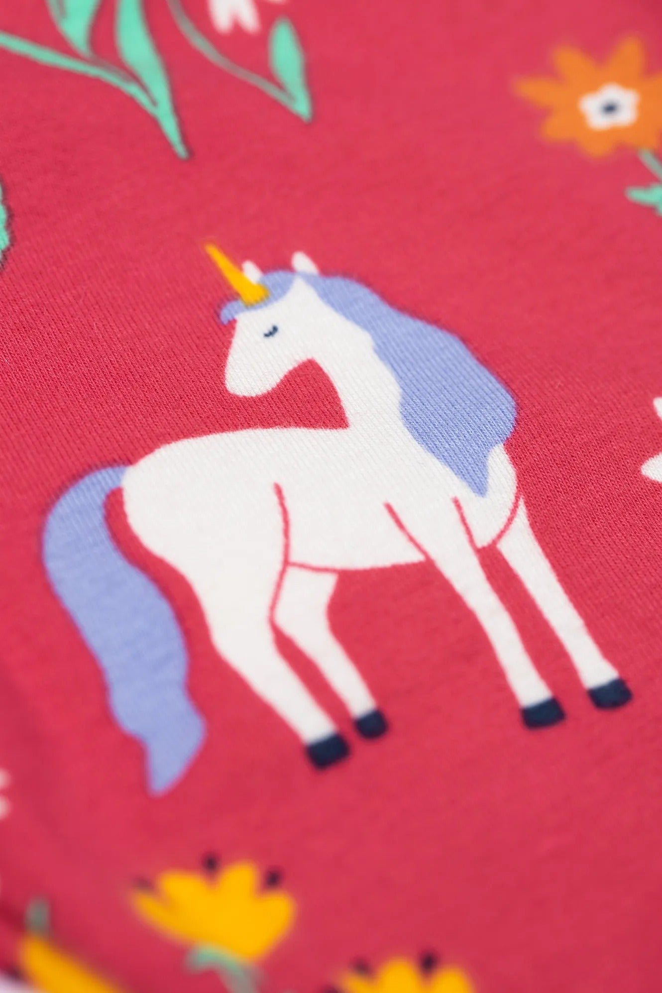 Unicorn design on a red fabric background with flowers