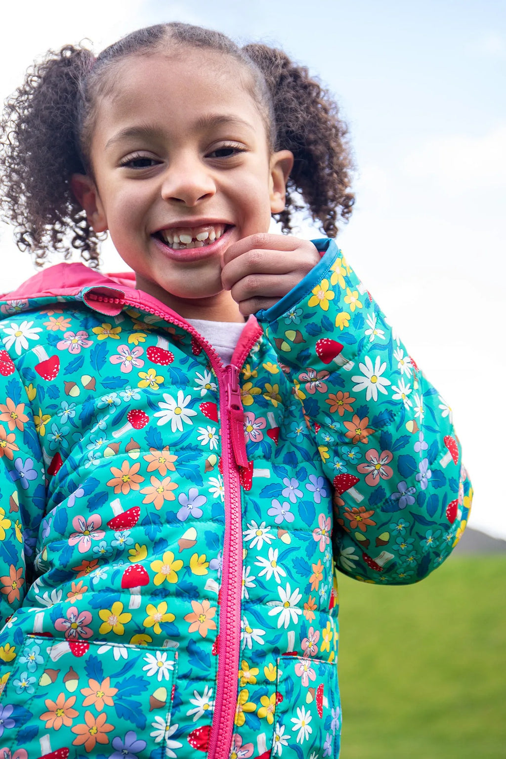 Young girl wearing a colorful floral jacket outdoors