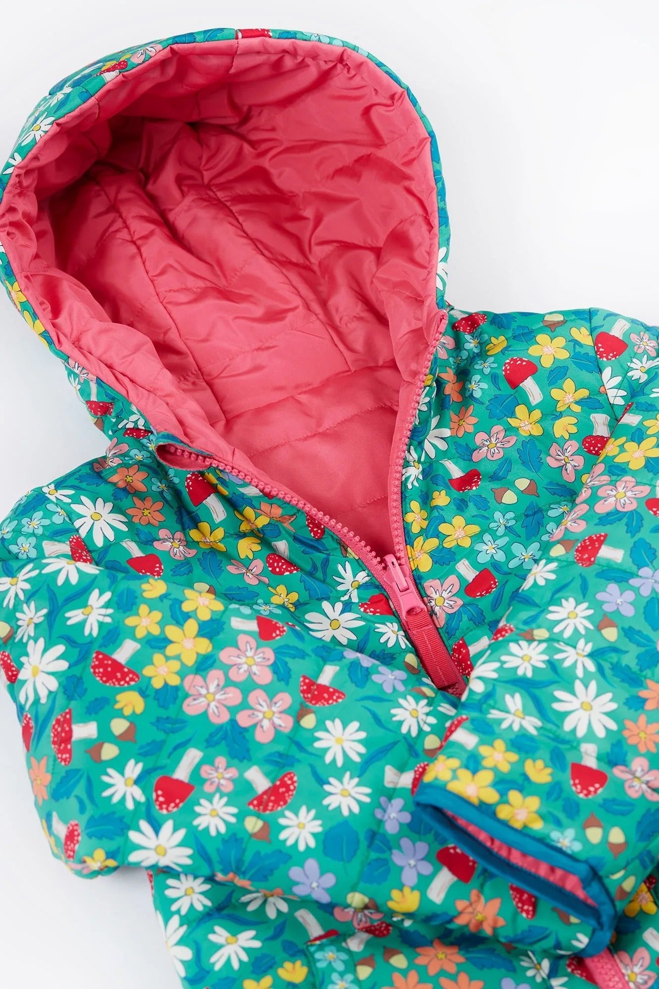 Floral-patterned jacket with pink interior on a white background