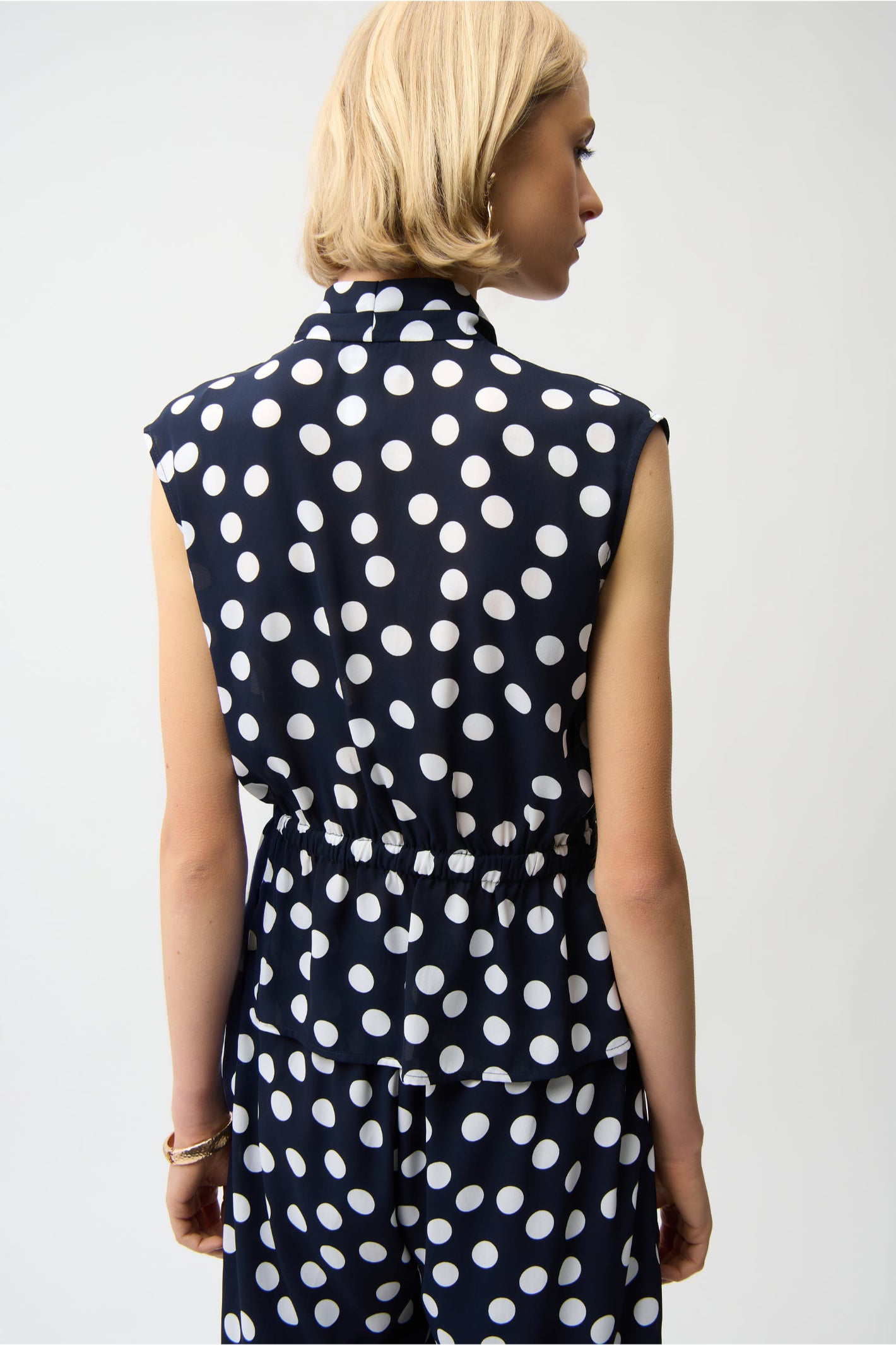 Back view of sleeveless navy georgette top with white dot print and peplum waist, Joseph Ribkoff 261250 Georgette Dot Print Wrap Peplum Top With Gold Buttons, shop Joseph Ribkoff at Dotique.