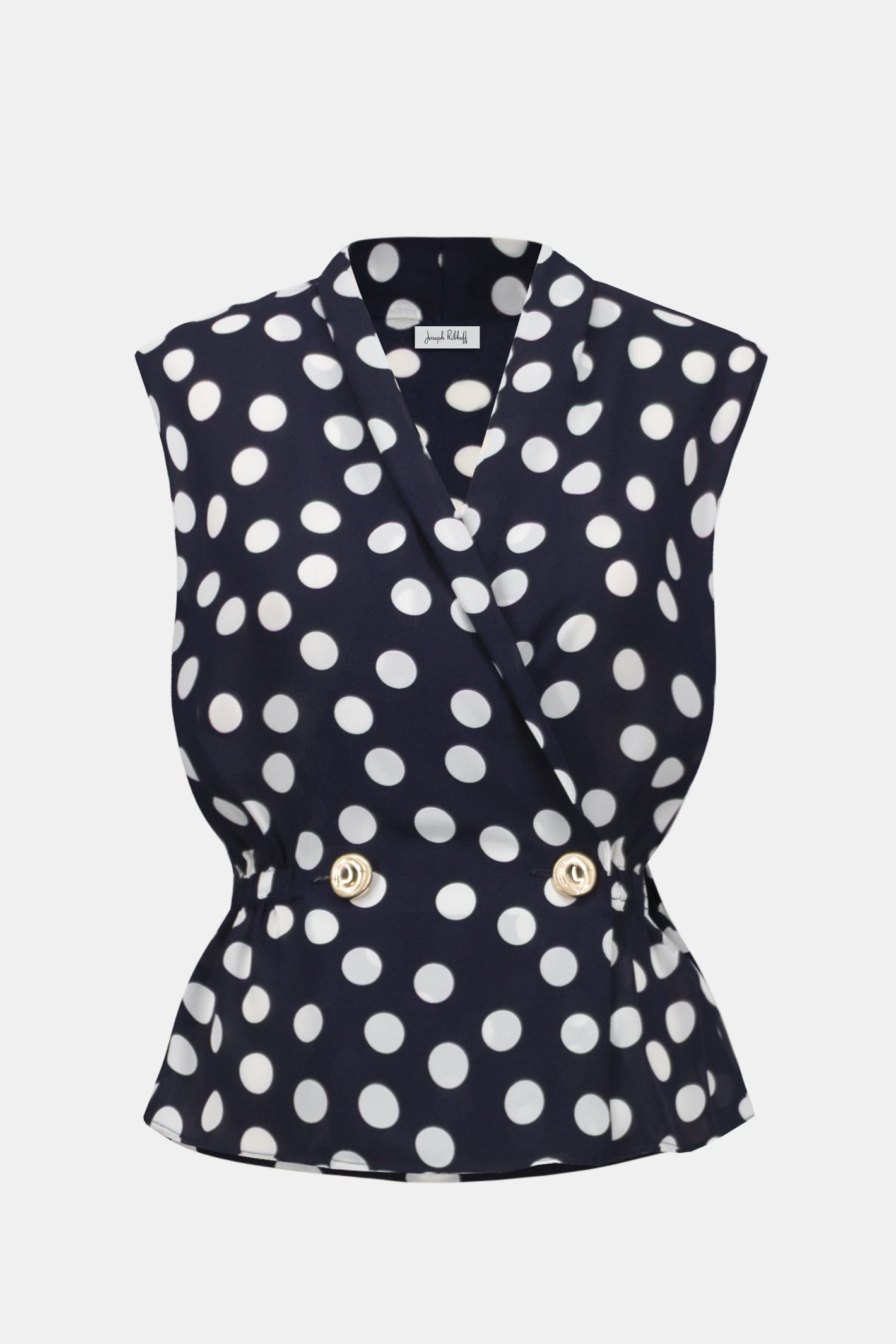 Sleeveless navy and white polka dot wrap top with peplum waist and gold buttons, Joseph Ribkoff 261250 Georgette Dot Print Wrap Peplum Top With Gold Buttons, shop Joseph Ribkoff at Dotique.