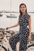 Model wearing Joseph Ribkoff 261250 Georgette Dot Print Wrap Peplum Top With Gold Buttons in navy with white dots by Joseph Ribkoff, shop Joseph Ribkoff at Dotique.