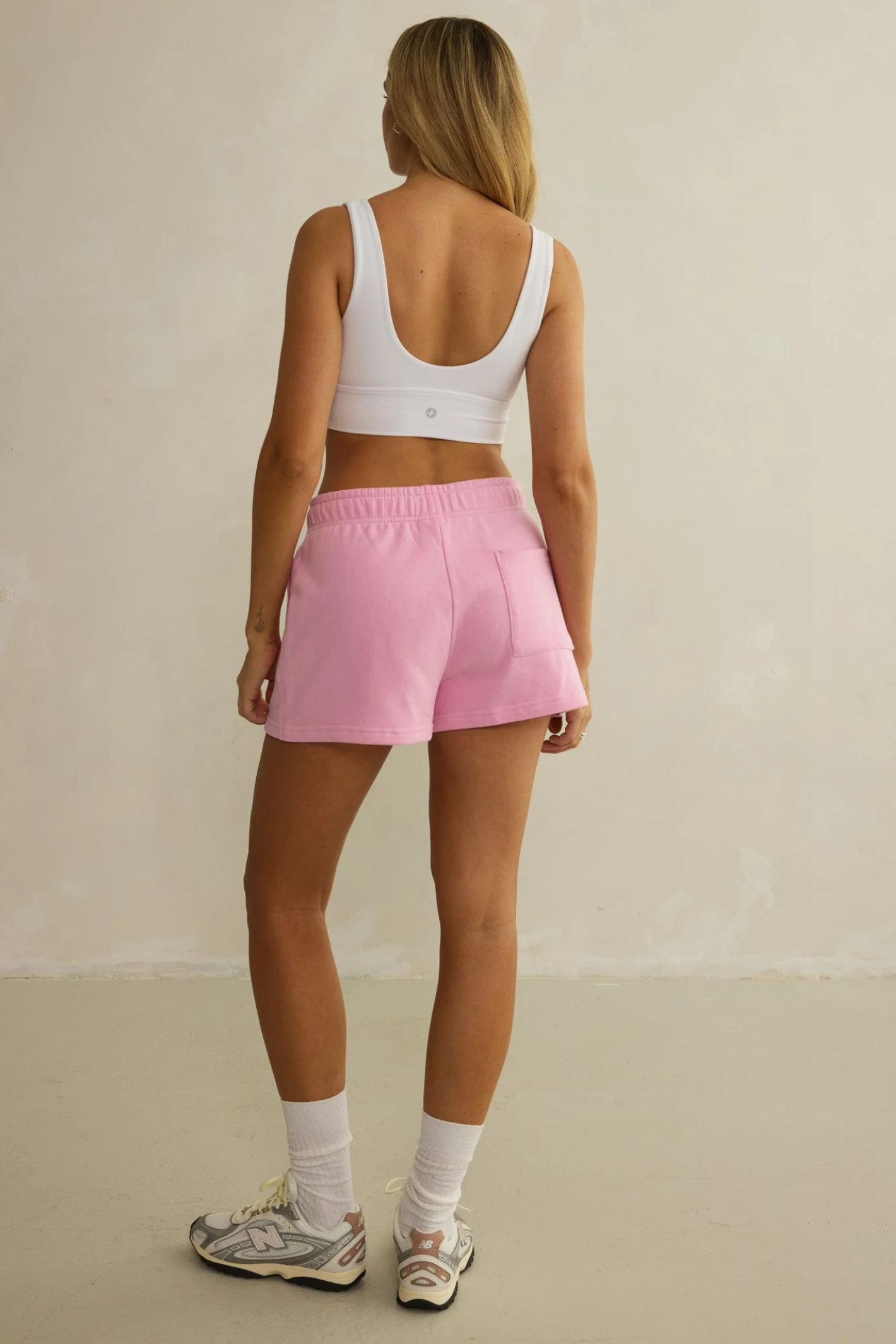 Rear view of model wearing Gym+Coffee Daily Cotton Shorts in Pink Blossom by gym+coffee, shop gym+coffee at Dotique.