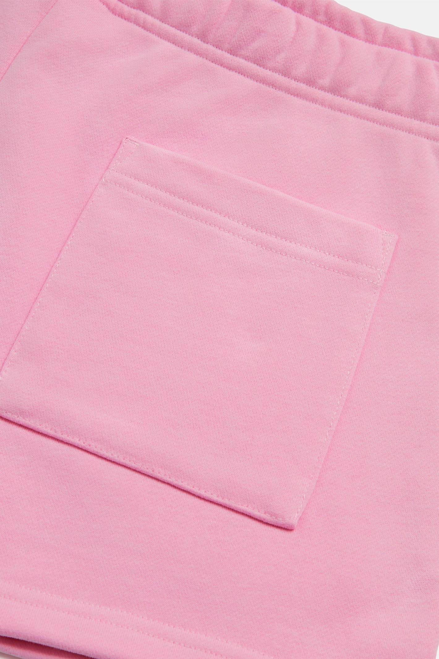 Close-up of back pocket on Gym+Coffee Daily Cotton Shorts in Pink Blossom by gym+coffee shop gym+coffee at Dotique