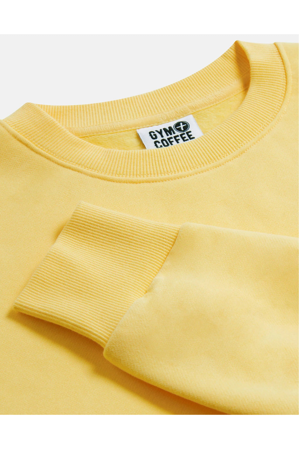 Close-up of ribbed neckline and cuff on Gym+Coffee Urban Crewneck in Lemon Sorbet, shop Gym+Coffee at Dotique for layering