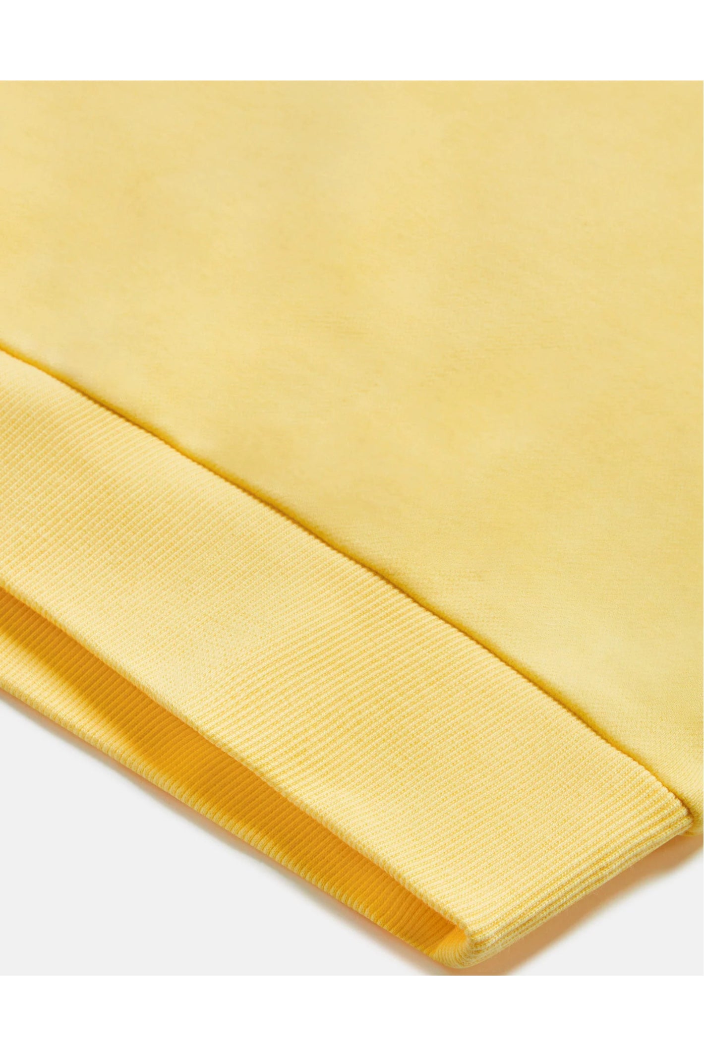 Close-up of ribbed cuff detail on Gym+Coffee Urban Crewneck in Lemon Sorbet by Gym+Coffee shop Dotique for casual layering
