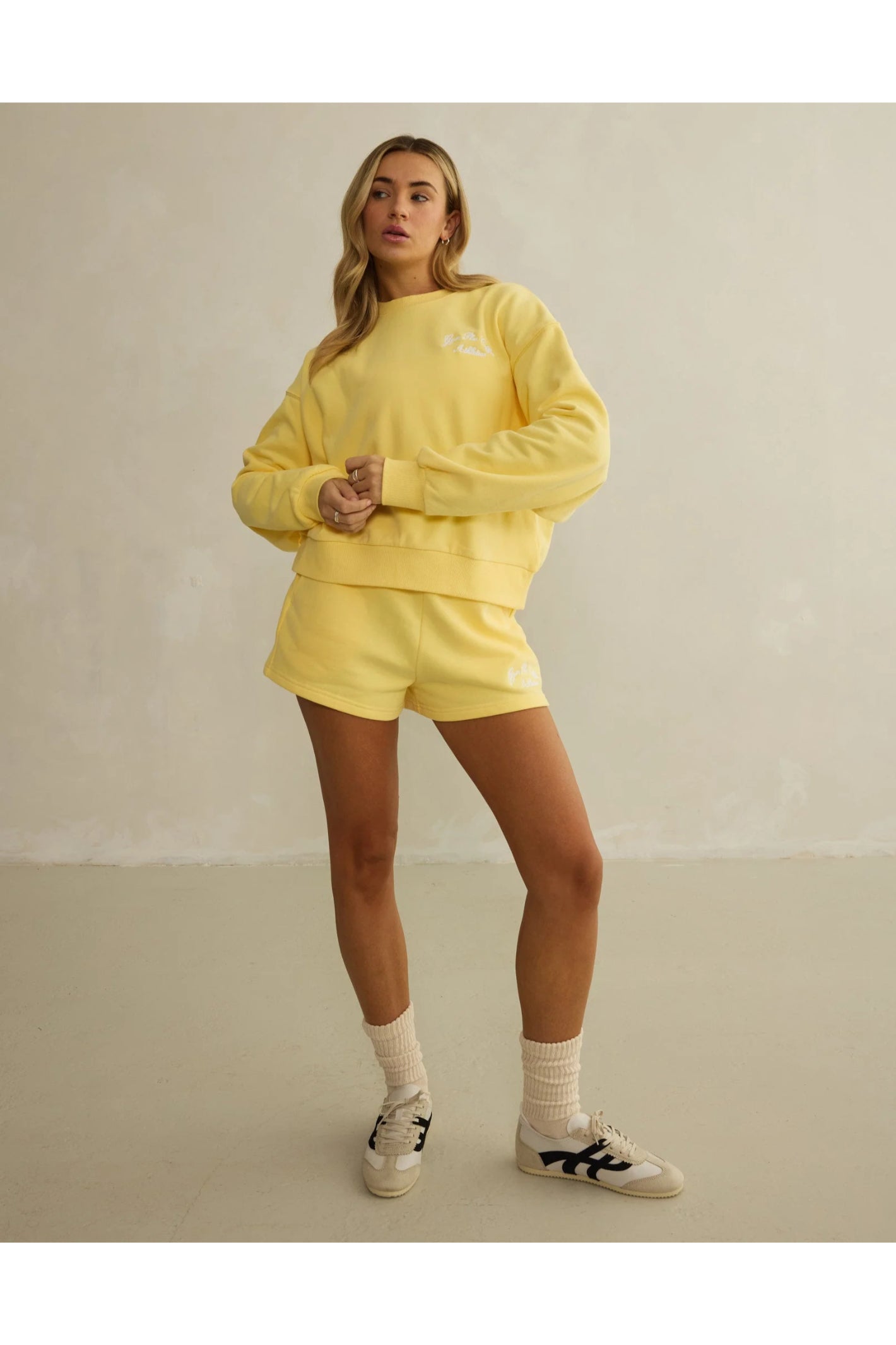 Model wearing Gym+Coffee Urban Crewneck in Lemon Sorbet relaxed fit soft knit, shop Gym+Coffee at Dotique for casual layers