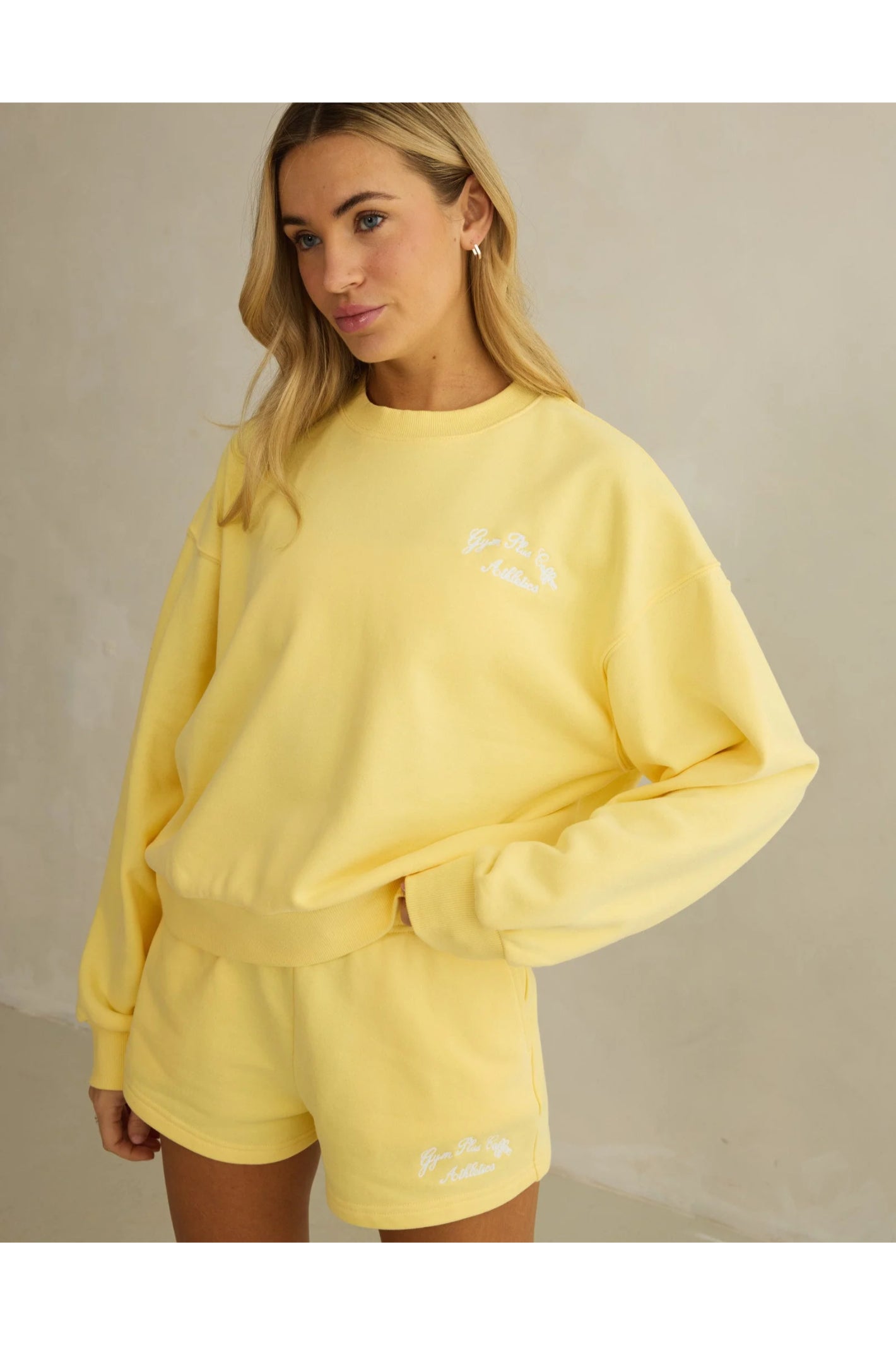 Model wearing Gym+Coffee Urban Crewneck in Lemon Sorbet relaxed fit soft knit, shop Gym+Coffee at Dotique for activewear layers