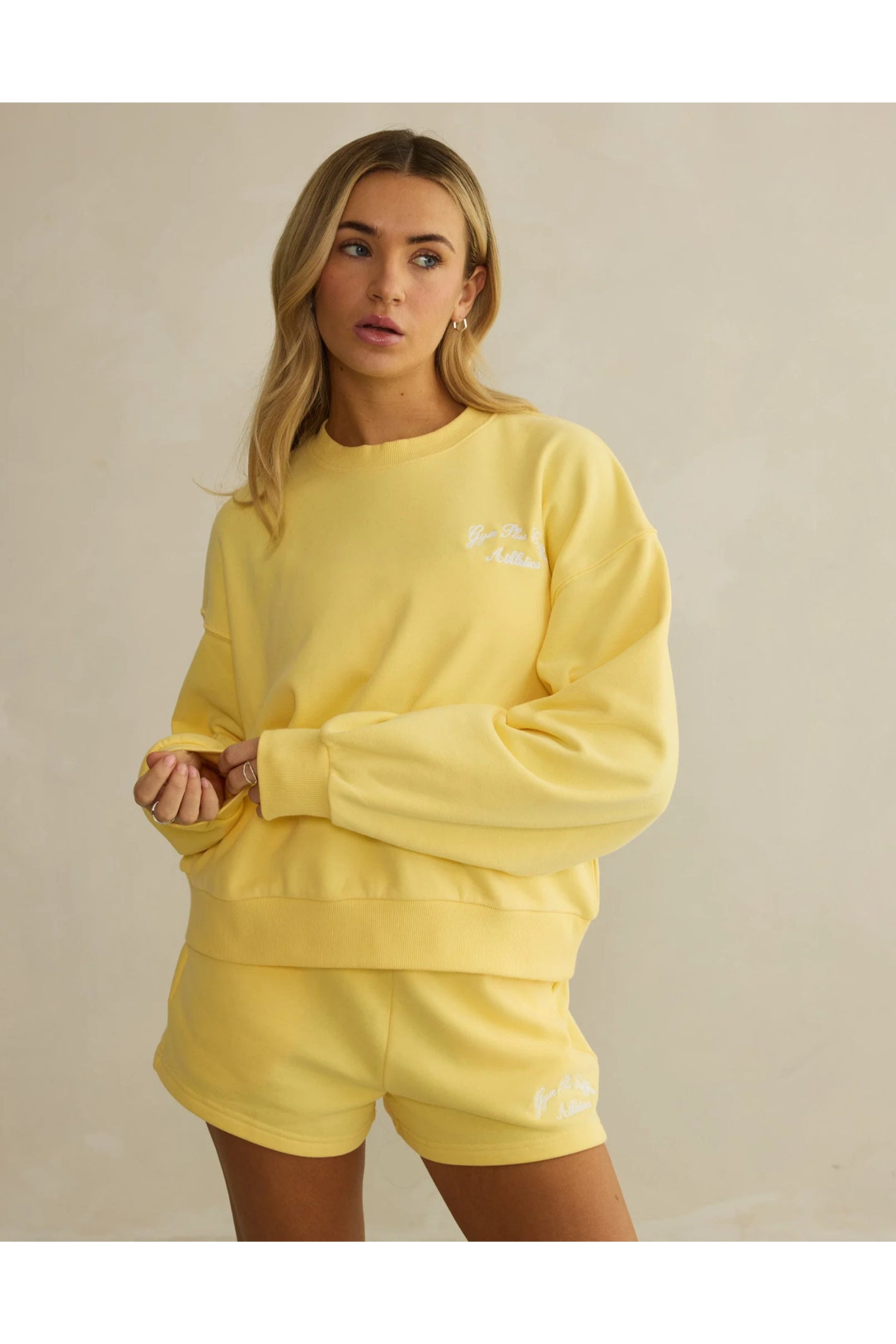 Model wearing Gym+Coffee Urban Crewneck in Lemon Sorbet soft lightweight knit, shop Gym+Coffee at Dotique for activewear layers