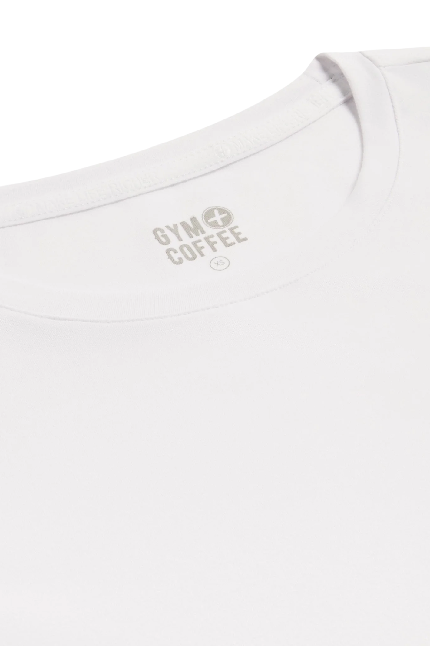 Close-up of the Gym+Coffee Daily Urban Tee in Ultra White neckline featuring the Gym+Coffee logo Shop Gym+Coffee at Dotique