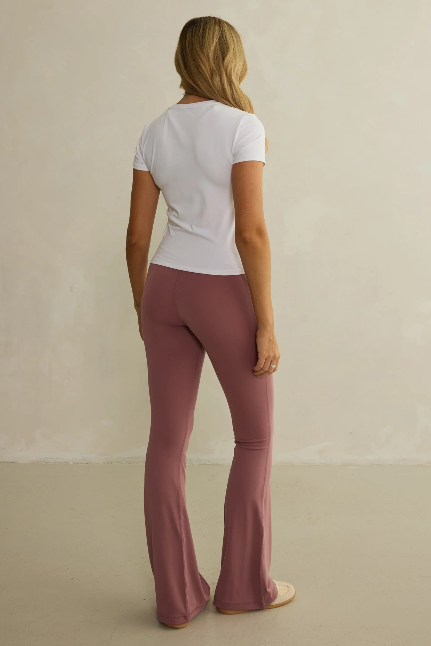 Woman wearing Gym+Coffee Daily Urban Tee in Ultra White, shown from back, shop Gym+Coffee at Dotique for stylish casual wear.