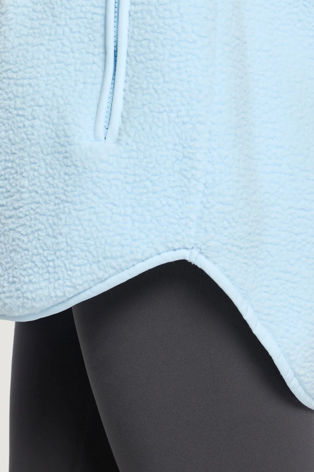 Gym+Coffee Horizon Longline Half Zip Glacial Blue fleece close-up over black leggings. Shop Gym+Coffee at Dotique