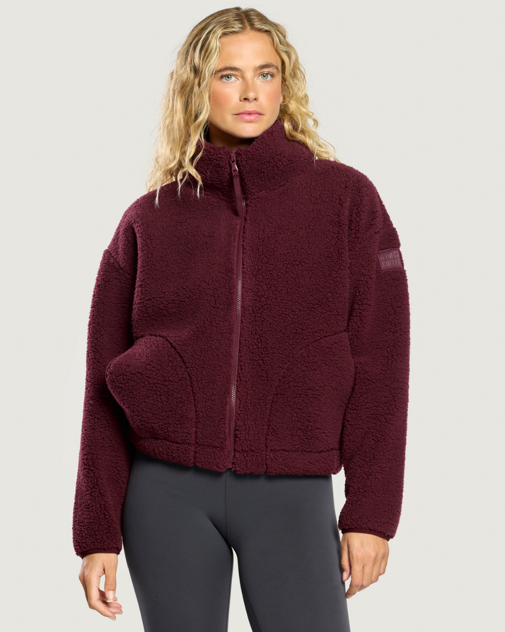 Model wearing Gym+Coffee Industry Fleece High Collar Jacket Cherry Crush. Shop Gym+Coffee at Dotique.