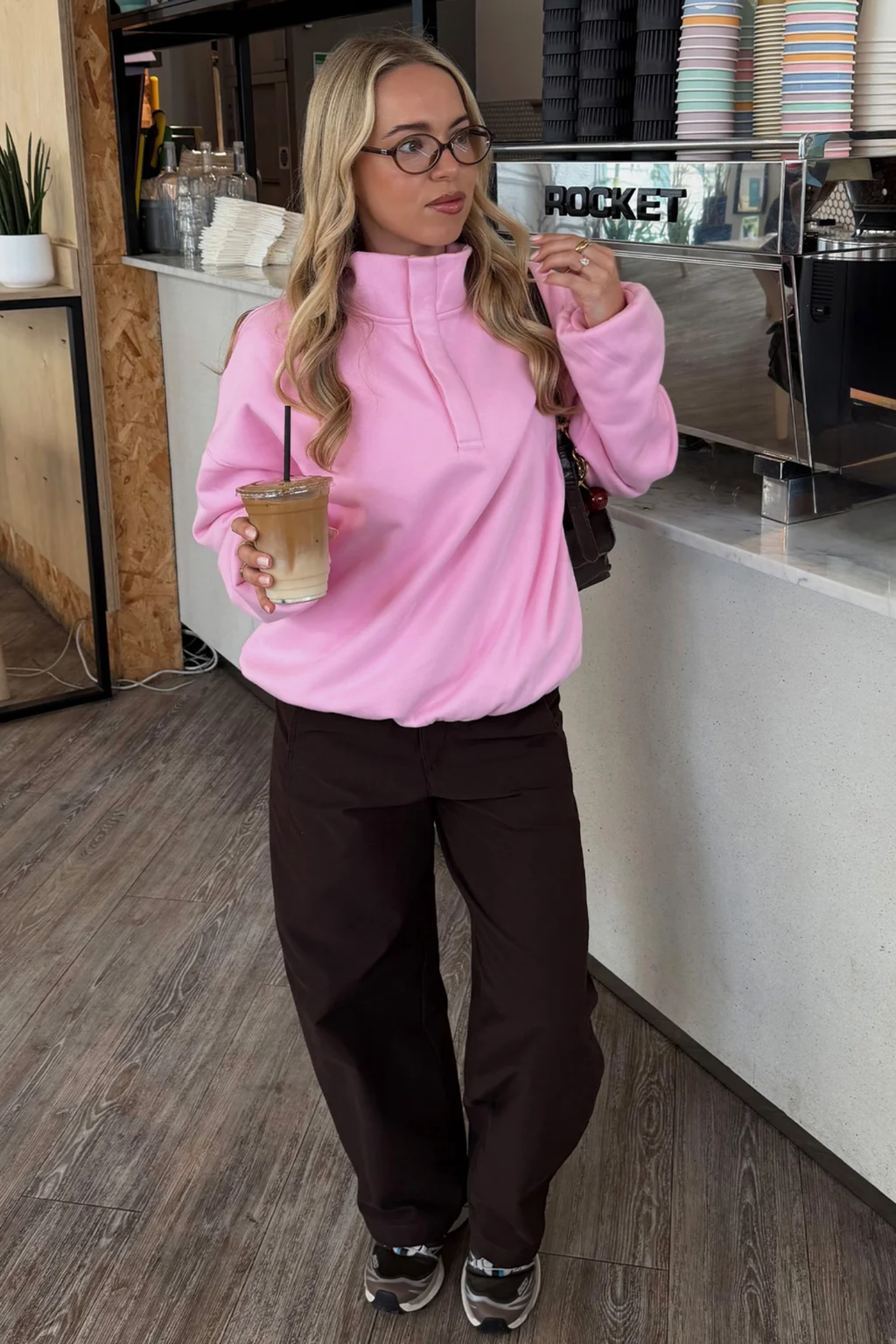Gym+Coffee Knit Snap Collar Sierra Sweatshirt Pink Blossom worn by woman. Shop Gym+Coffee at Dotique