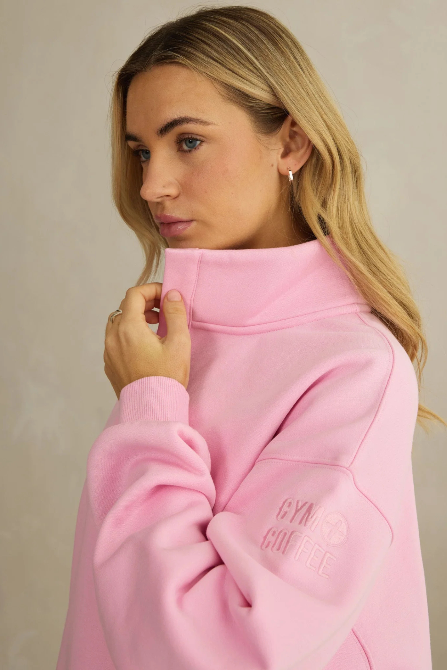 Side view of woman wearing Gym+Coffee Snap Collar High Waist Sweatshirt Pink Blossom by gym+coffee, shop gym+coffee at Dotique.