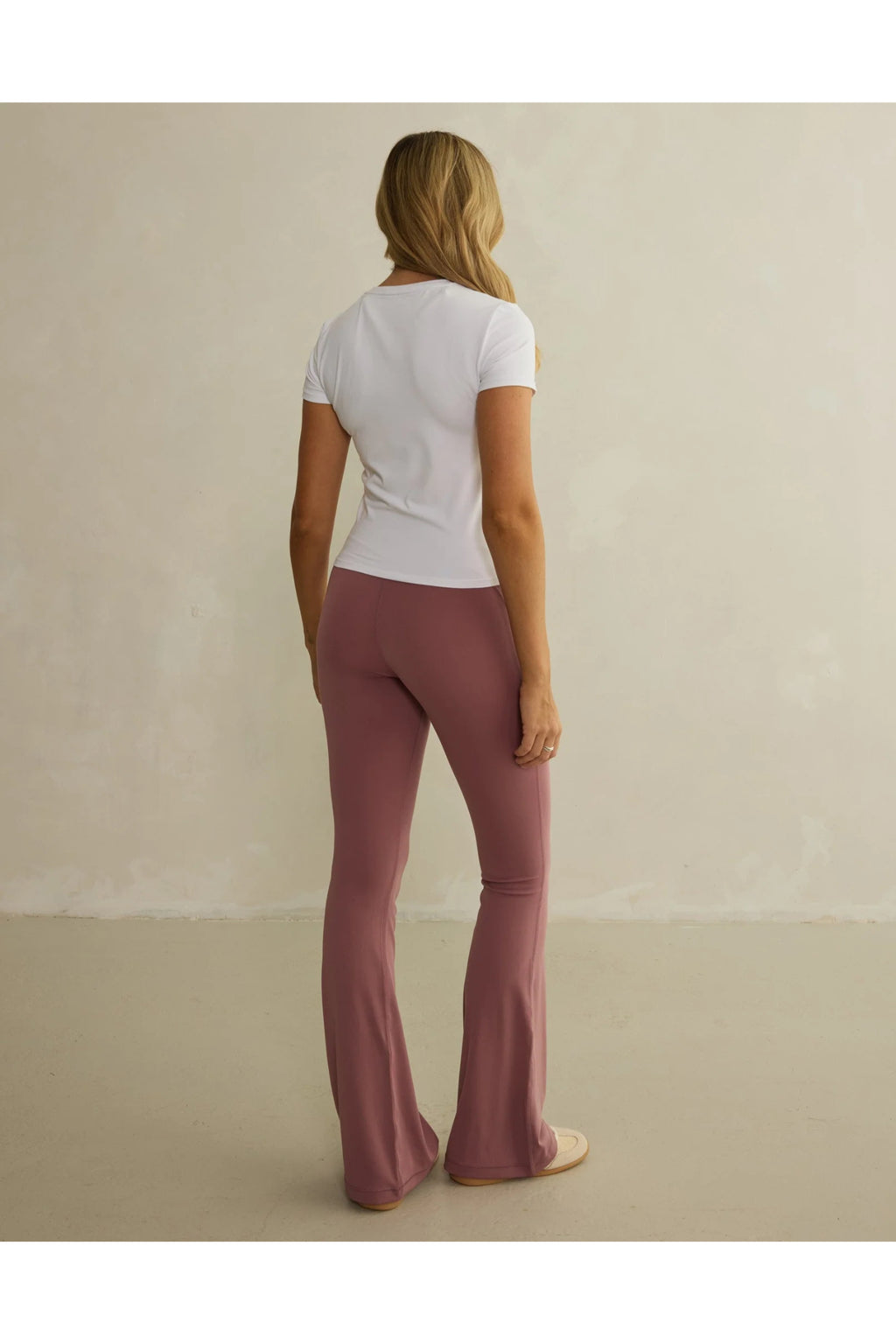 Rear view of model wearing Gym+Coffee Soft Motion Flares - Terra Rose flared leggings, shop Gym+Coffee at Dotique for versatile activewear
