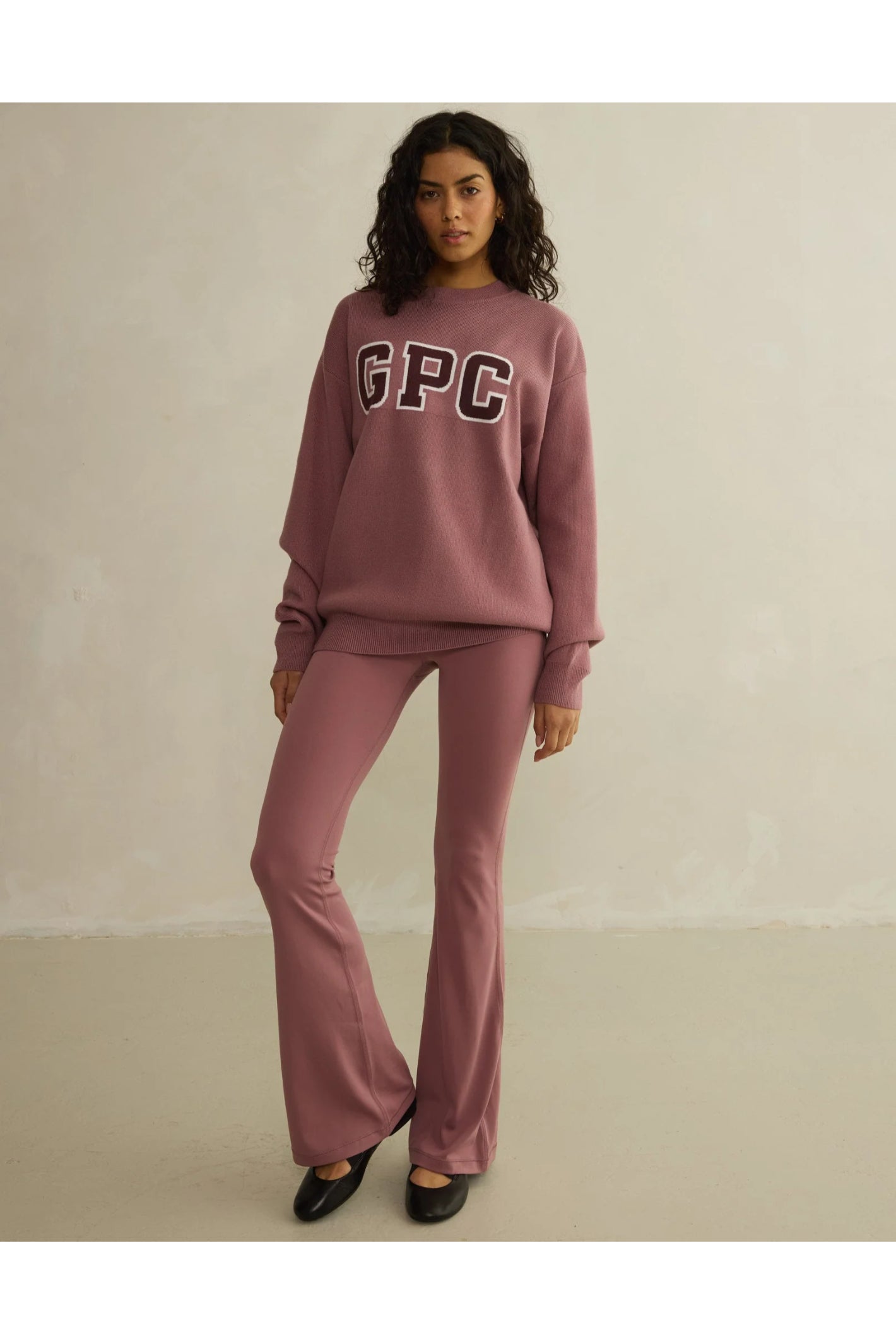 Model wearing Gym+Coffee Soft Motion Flares - Terra Rose flared leggings styled casual, shop Gym+Coffee at Dotique