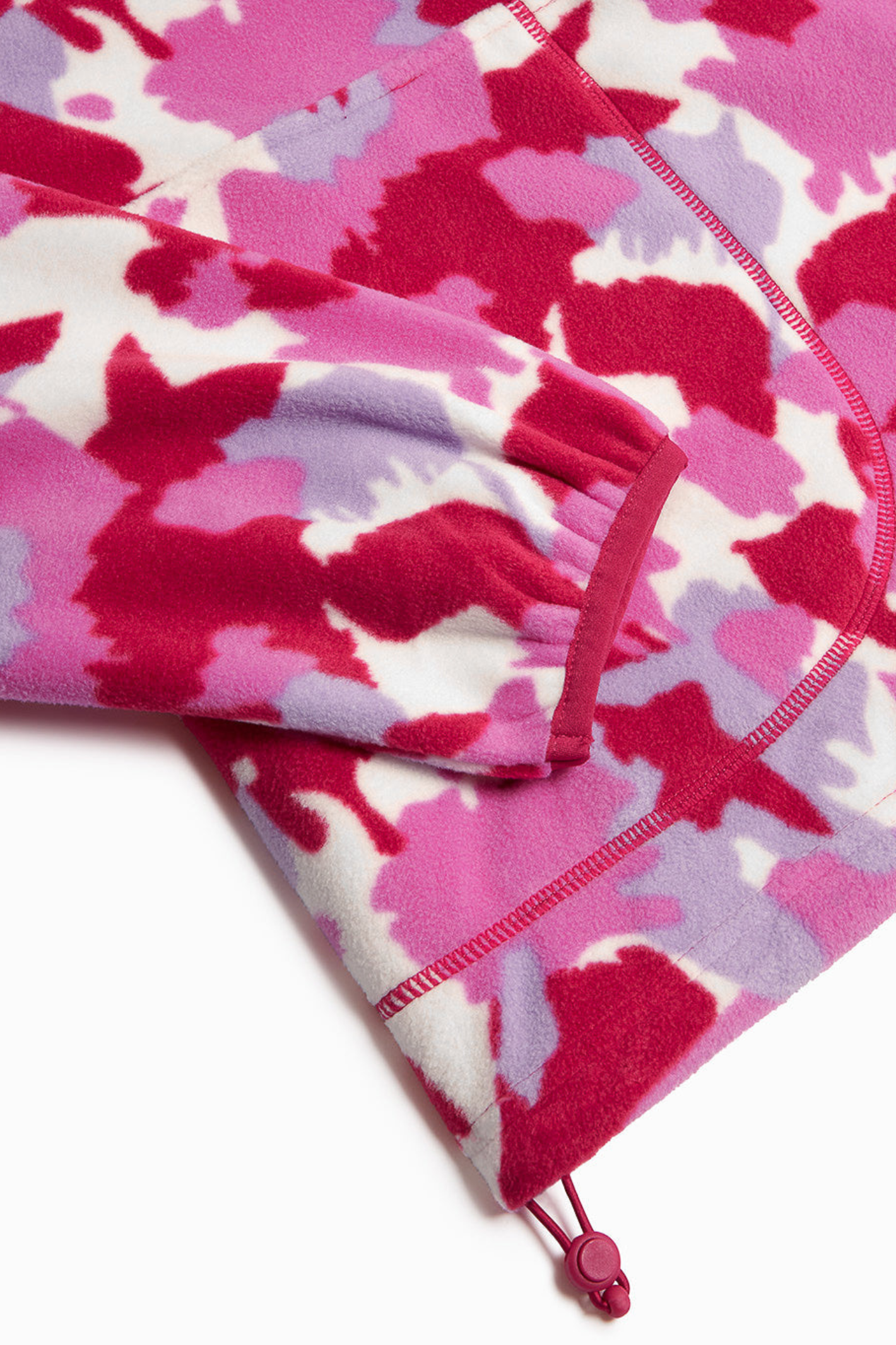 Soft Pink Pop Print polar fleece from Gym+Coffee with snap-front and relaxed fit. Lightweight and cosy with zip pockets — a statement layer for everyday wear.