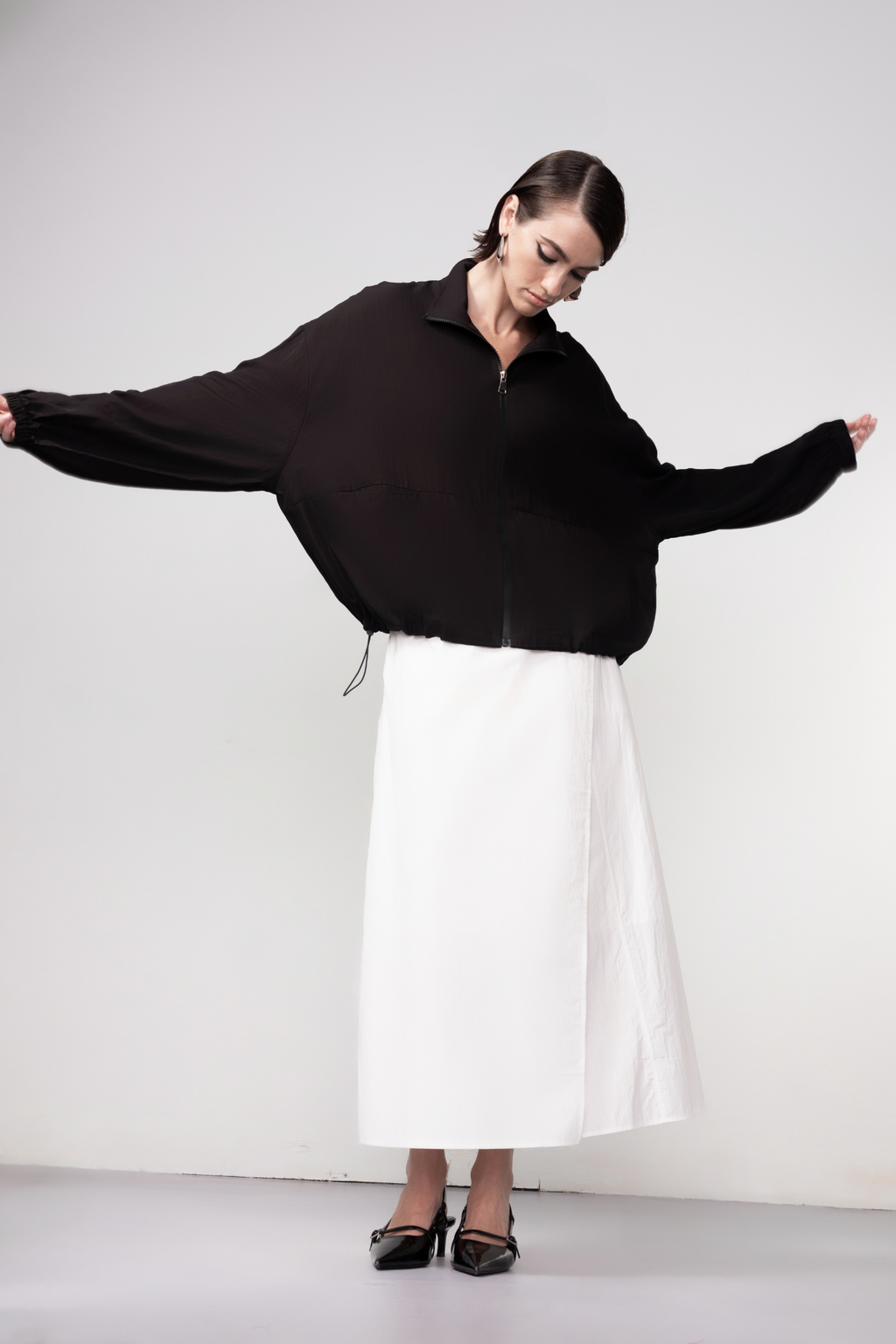 Haako black zip-front bomber jacket with minimalist design and modern silhouette, styled for effortless layering