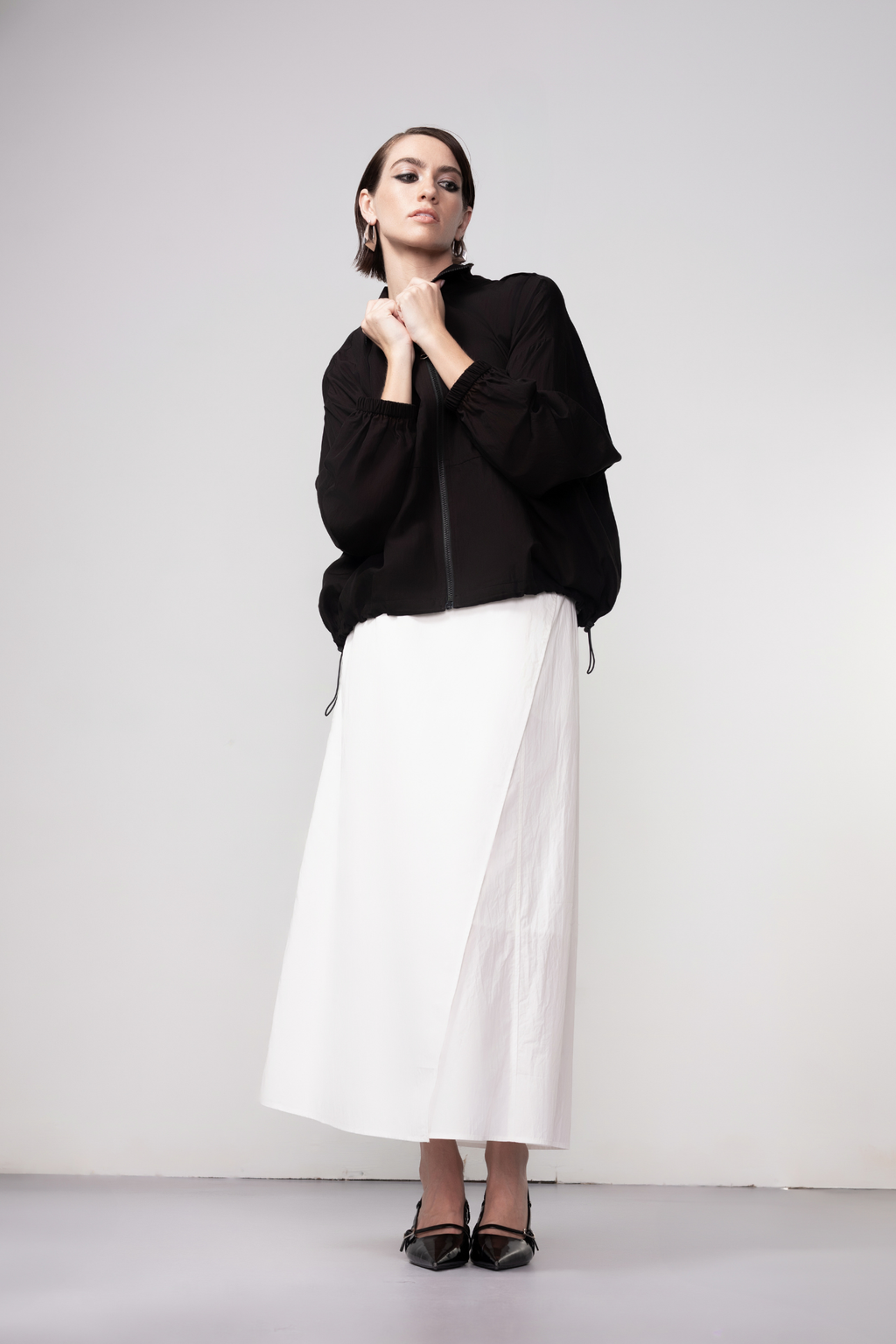 Haako black zip-front bomber jacket with minimalist design and modern silhouette, styled for effortless layering