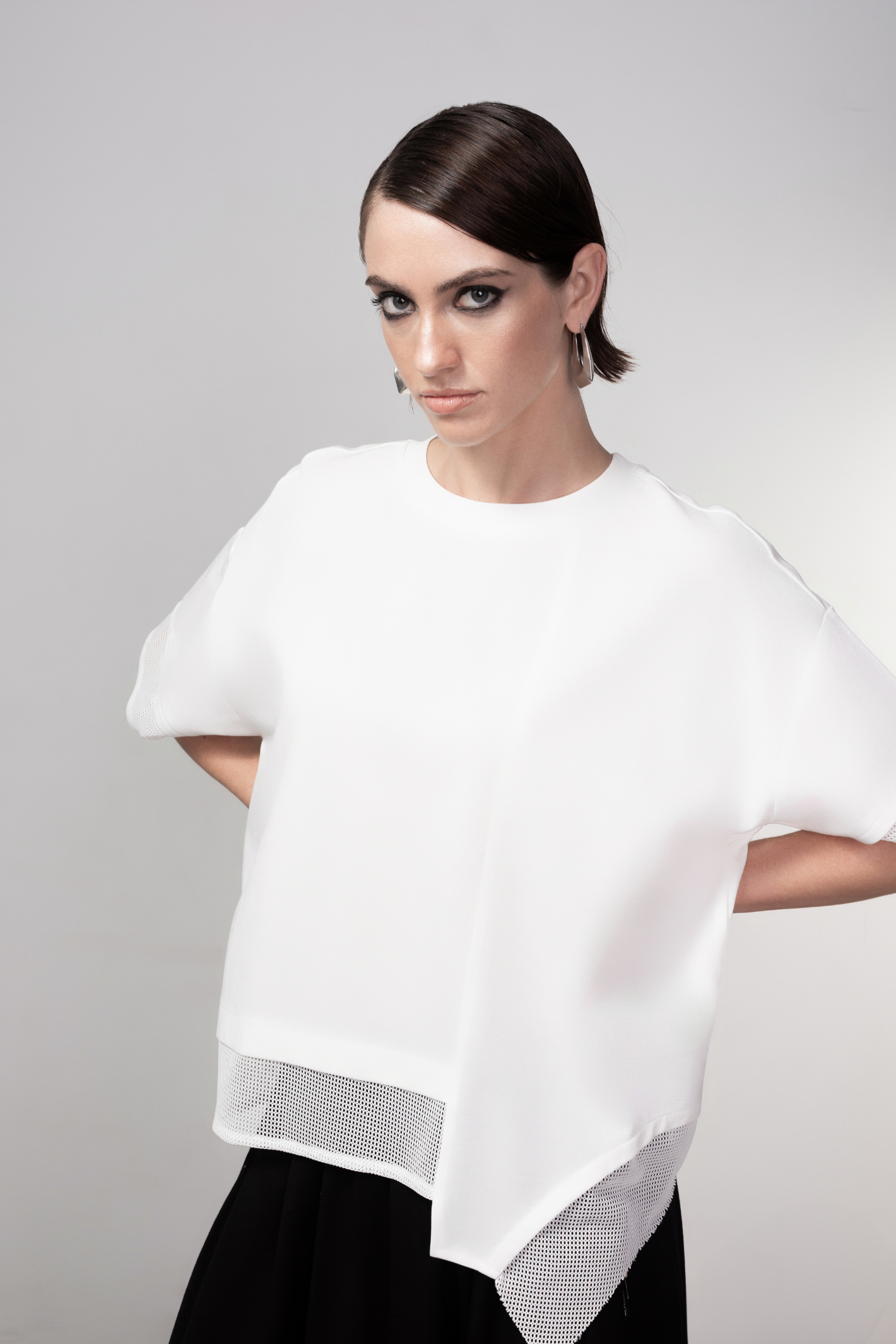 Haako black short sleeve top with mesh trim detail and minimalist silhouette, styled as a modern wardrobe staple
