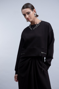 Shop the Haako H2024 black knit top with twin zip pocket detail at the hem. A relaxed crew neck sweat top for effortless everyday styling at Dotique.