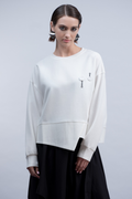Shop the Haako H2046 white sweat top with quirky button and safety pin embroidered detail. An oversized crew neck top with asymmetric hem at Dotique.