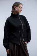 Shop the Haako H2048 black sweat jacket with asymmetric zip and stand collar. An oversized, sporty-luxe layering piece at Dotique.