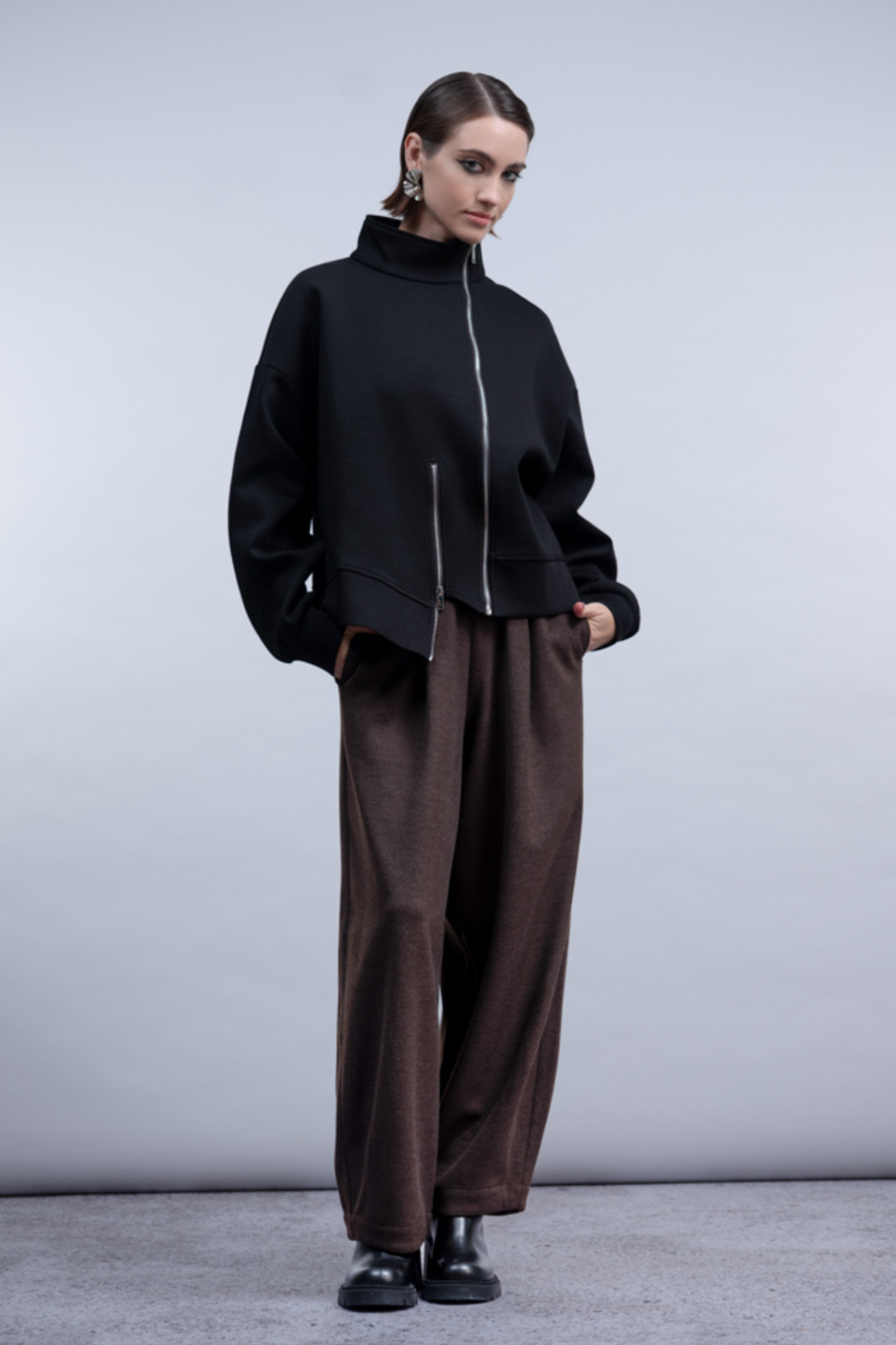 Shop the Haako H2048 black sweat jacket with asymmetric zip and stand collar. An oversized, sporty-luxe layering piece at Dotique.