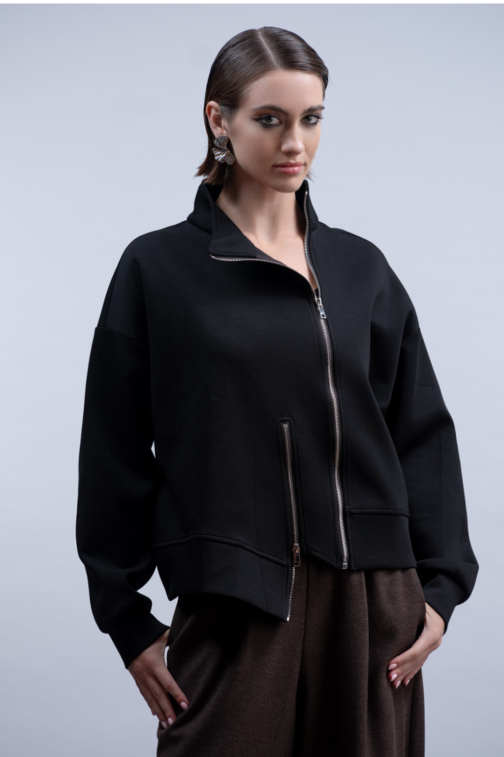 Shop the Haako H2048 black sweat jacket with asymmetric zip and stand collar. An oversized, sporty-luxe layering piece at Dotique.