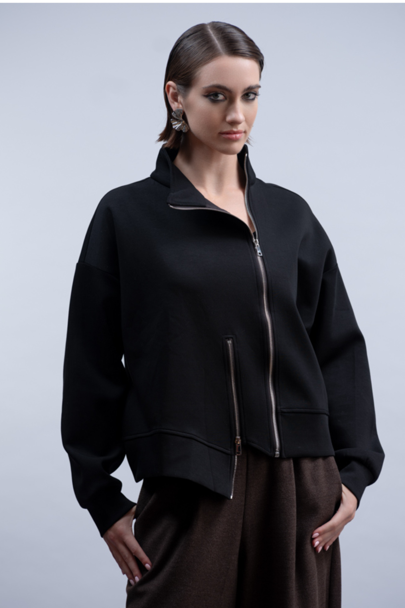 Shop the Haako H2048 black sweat jacket with asymmetric zip and stand collar. An oversized, sporty-luxe layering piece at Dotique.