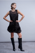 Shop the Haako H2060 black mini dress with sheer overlay and 3D rosette hem detail. A statement occasion dress at Dotique.