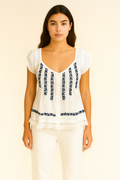 Front view of a woman wearing Handprint Dream Apparel NE7118 Thalassa Top White Black with navy embroidery and fringe detailing by Handprint Dream Apparel. Shop Handprint Dream Apparel at Dotique.
