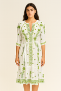 Front view of a model wearing Handprint Dream Apparel NE7135 Grace Dress White Green with embroidered green floral accents and waist tie by Handprint Dream Apparel. Shop Handprint Dream Apparel at Dotique.