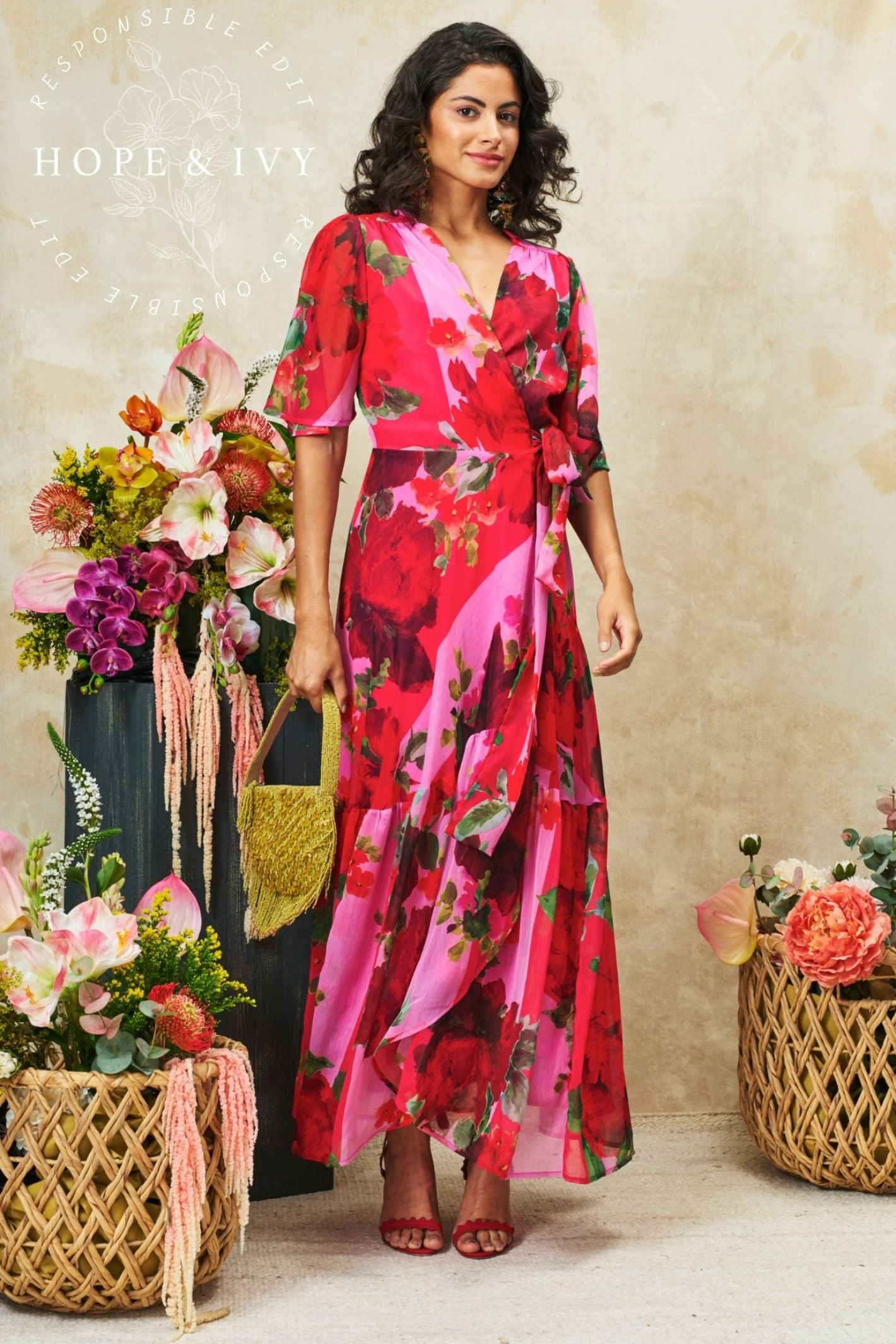 Flattering wrap maxi dress by Hope & Ivy in a pink and red floral print. Flutter sleeves, tie waist and flowing skirt. Shop Hope & Ivy Dresses at Dotique.