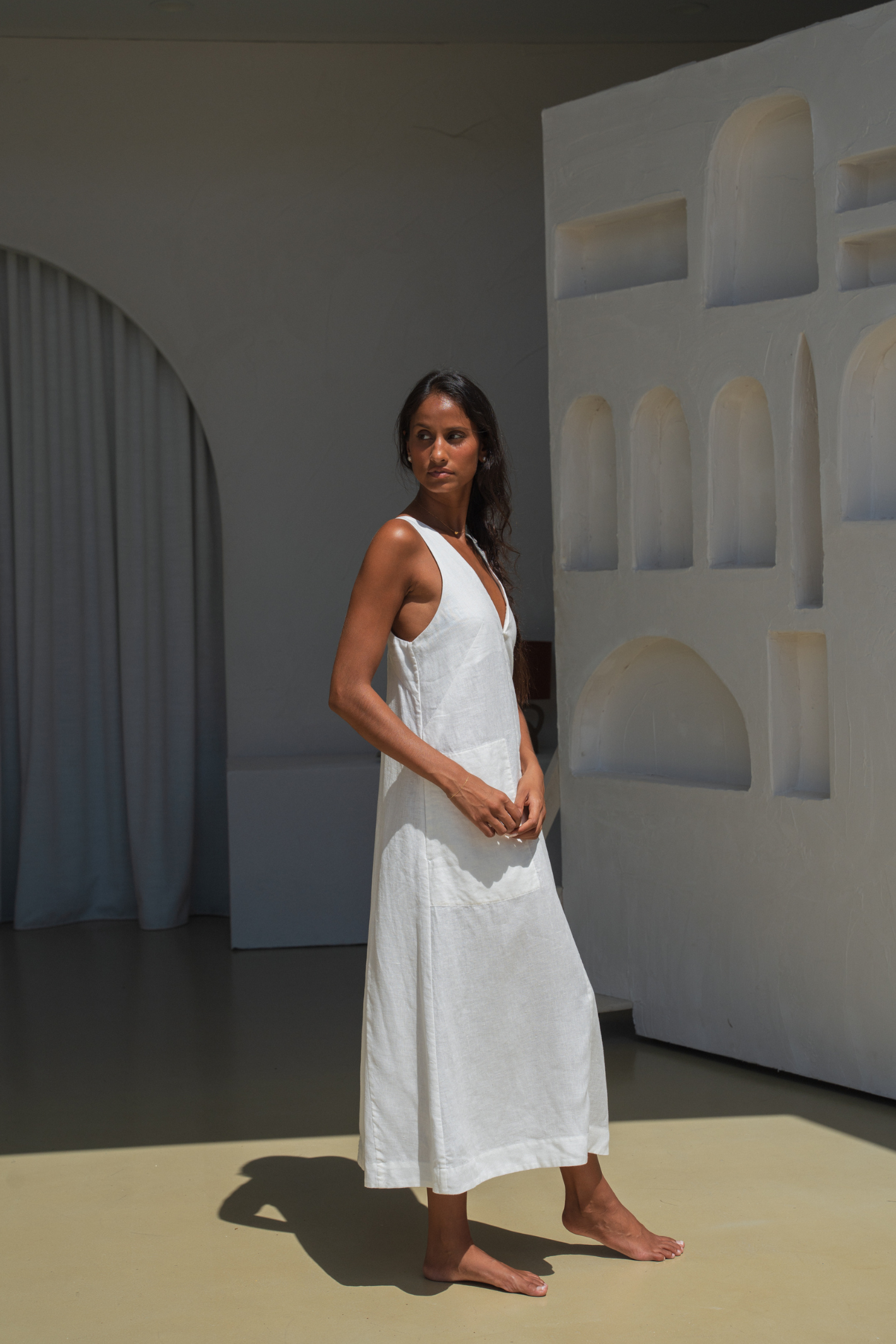 Model wearing Lilly Pilly LP-D018 Iris Linen Dress Ivory by Lilly Pilly in minimalist setting, shop Lilly Pilly at Dotique.