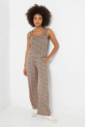 Woman wearing Joe Browns WM017A Summer Days Jersey Jumpsuit Black with a floral print, shop Joe Browns at Dotique for stylish jumpsuits.