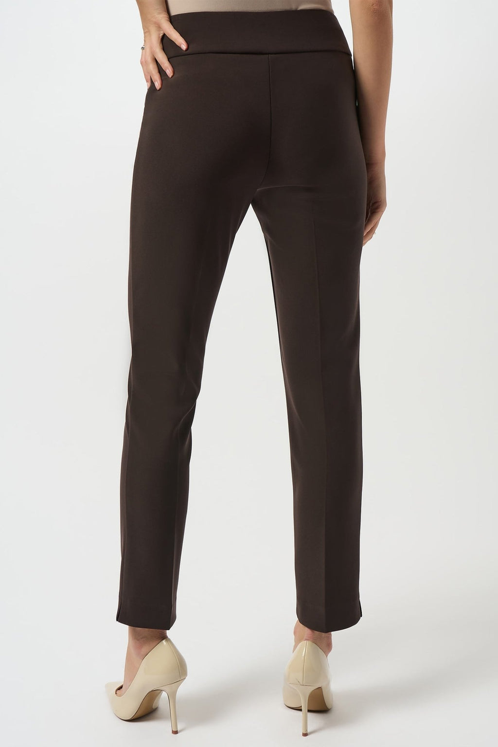 Dark brown pants worn by a person on a white background